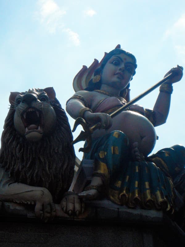 Sculpture of the goddess Mariamman and a lion at the entrance of Sri Mariamman Temple on South Bridge Road, Chinatown